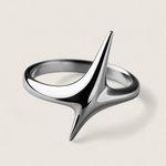 Silver ring with a unique design on a beige background