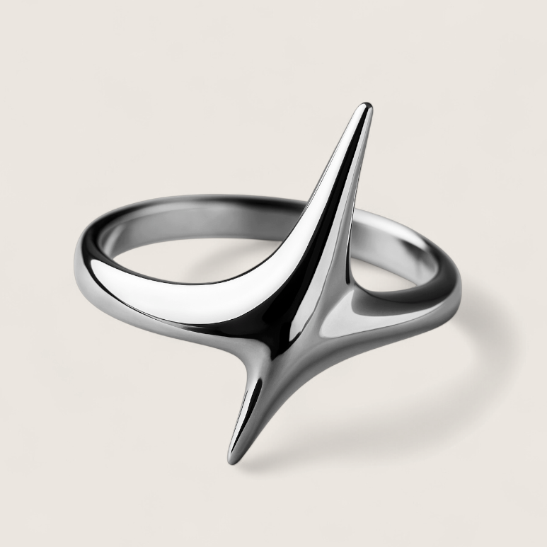 Silver ring with a unique design on a beige background