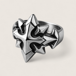 Silver spiked ring on a light gray background