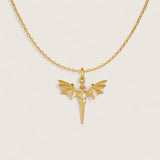 Gold necklace with a dragon-shaped pendant on a light beige background