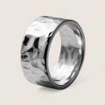 Silver ring with a textured surface on a light gray background