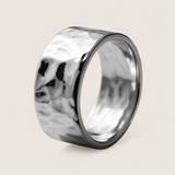 Silver ring with a textured surface on a light gray background
