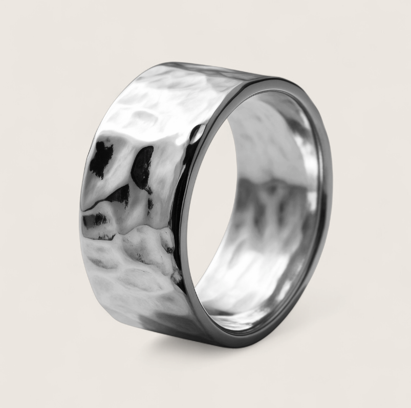Silver ring with a textured surface on a light gray background